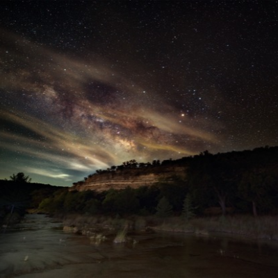 beth The Milky Way illuminates a brilliant blue, starry sky over a Hill Country river.