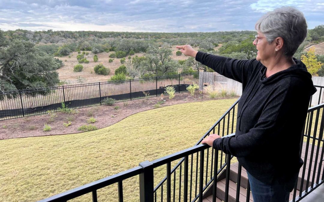 Yolanda Jones, a Dripping Springs resident and member of Save Our Hill Country, looks over the backyard views of her Caliterra home, which could be ruined by a four-lane highway, on Thursday, Nov. 18, 2021.