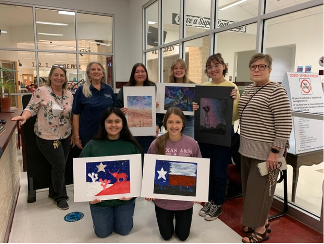 Displaying the prize-winning artwork at Johnson City High School are: Kneeling (l to r): Marlen Torres (1st place), Bree Herrera (5th place); Standing (l to r) Diane Hudson (Art Teacher), Vicki Guidry (BCFNS), Trinity Rendon (Honorable Mention), Neely Burrier (4th place), Ava Hermes (3rd place), and Barbara Hudson (BCFNS)