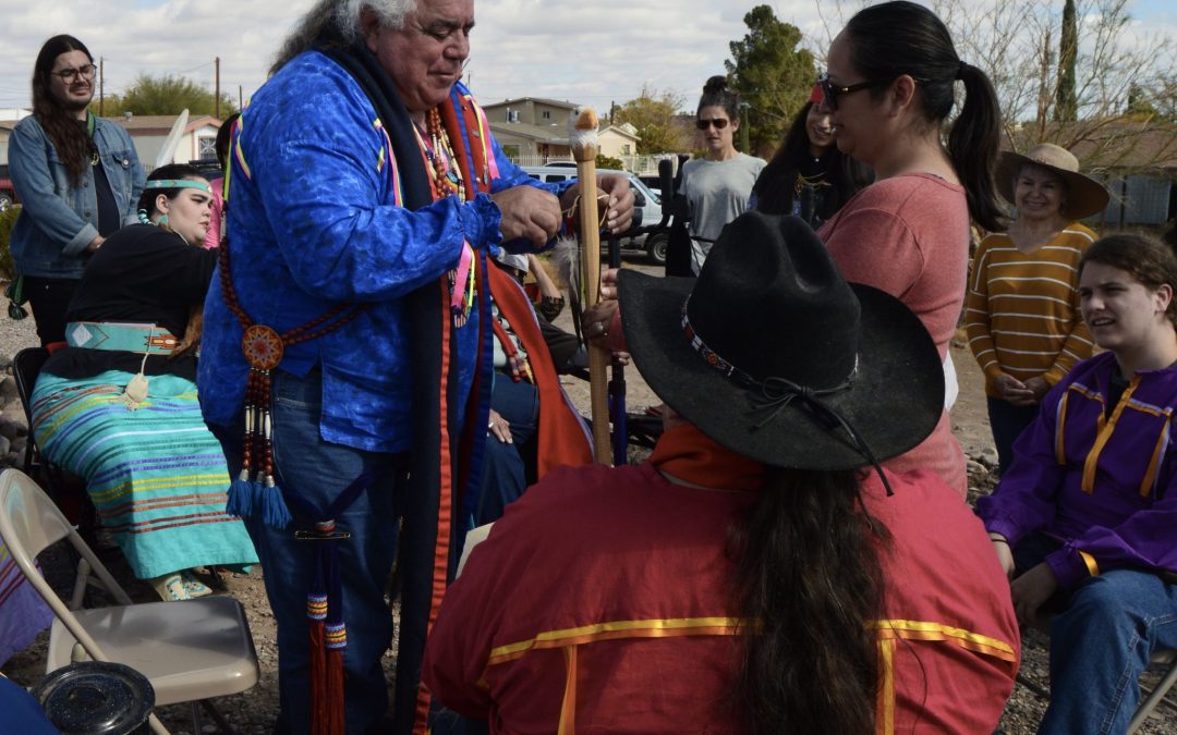 Robert Soto, Vice Chairman of the Lipan Apache Tribe of Texas, presents Christina Hernandez with an eagle feather at the Cementerio del Barrio de los Lipanes in Presidio. Tribal members traveled from around the country this weekend to celebrate local officials’ decision to transfer the cemetery to the tribe.