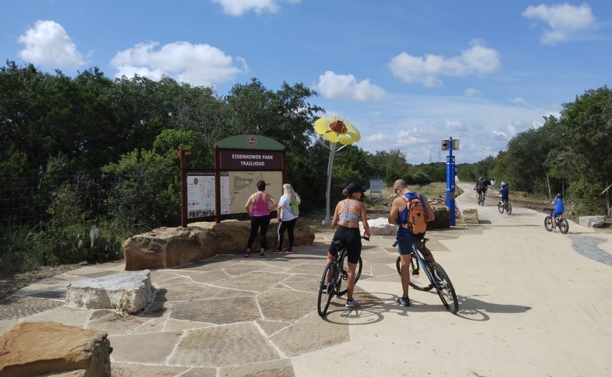 Users mill around the trailhead at Eisenhower Park that connects the Salado Creek Trail and Leon Creek Trail