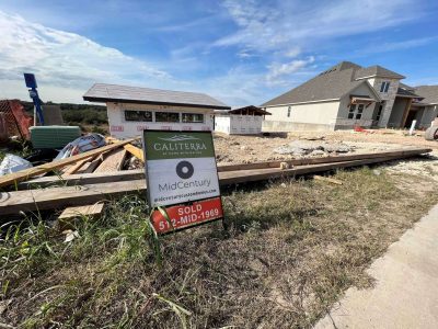 Photo of a home in development with a "for sale" sign
