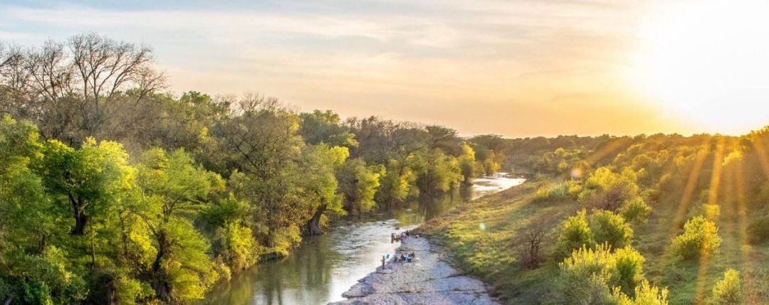 The sun rises over the Guadalupe river