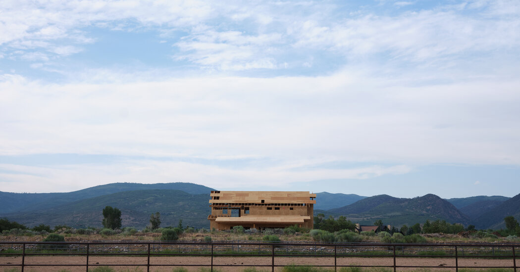 A half-constructed building set against the Utah landscape